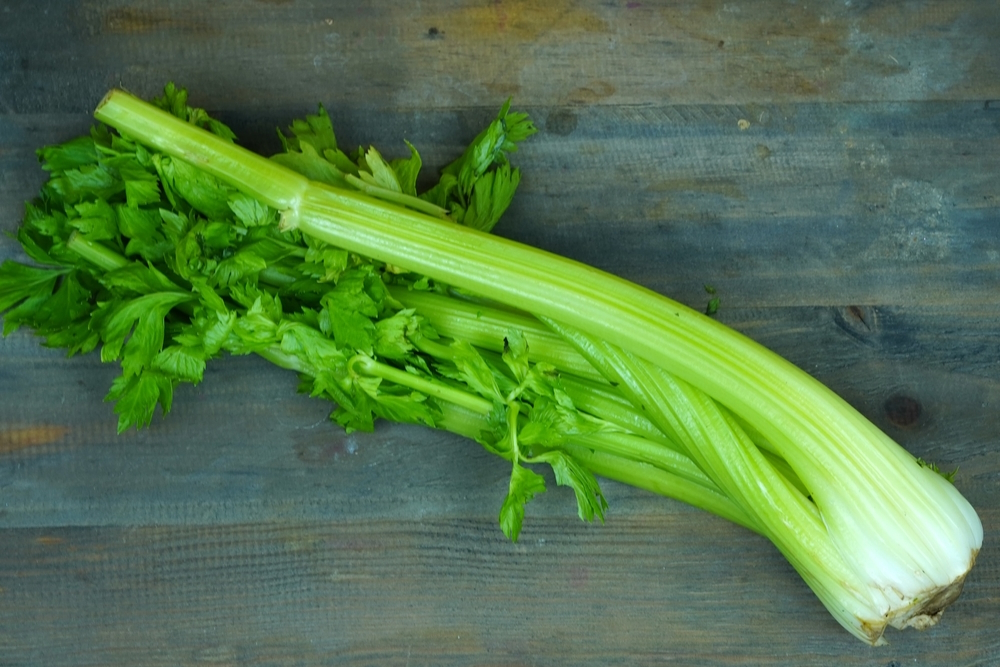 bunch-of-celery-stalks-on-a-wooden-table