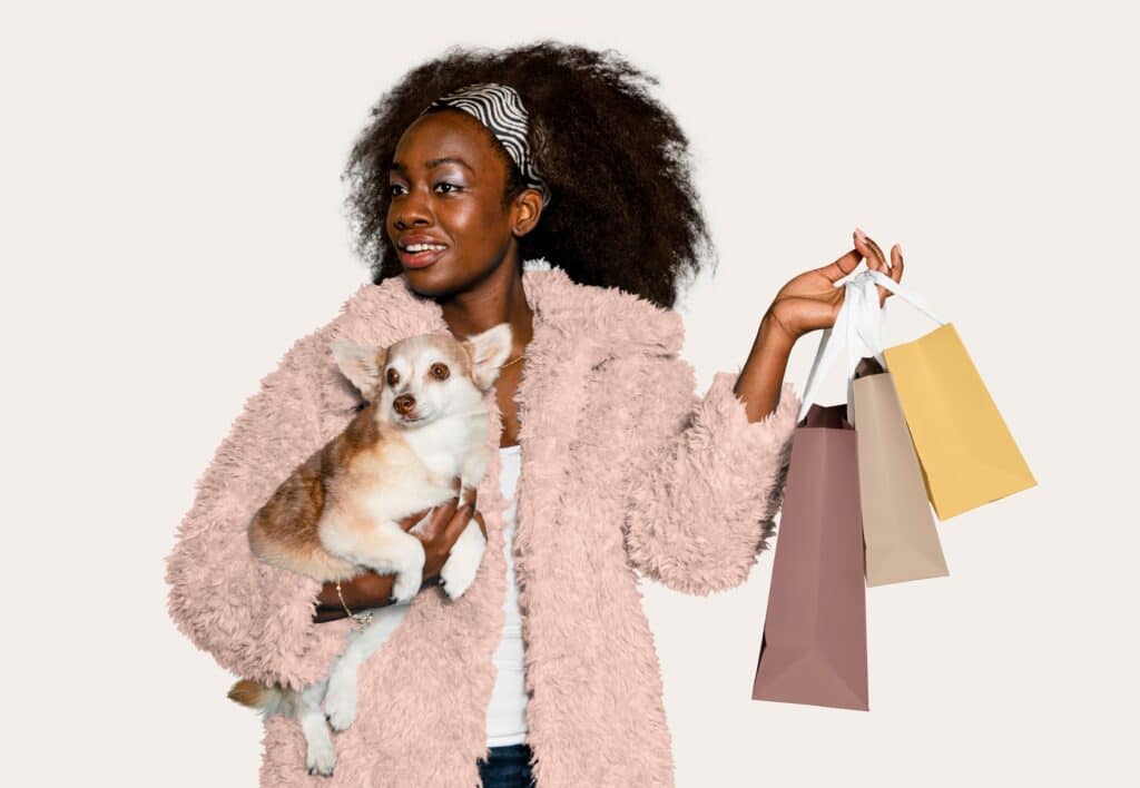 Woman Black Friday shopping while holding small dog