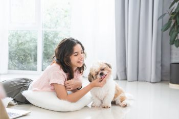 Dog leaning against its owner, seeking comfort and craving constant physical connection.